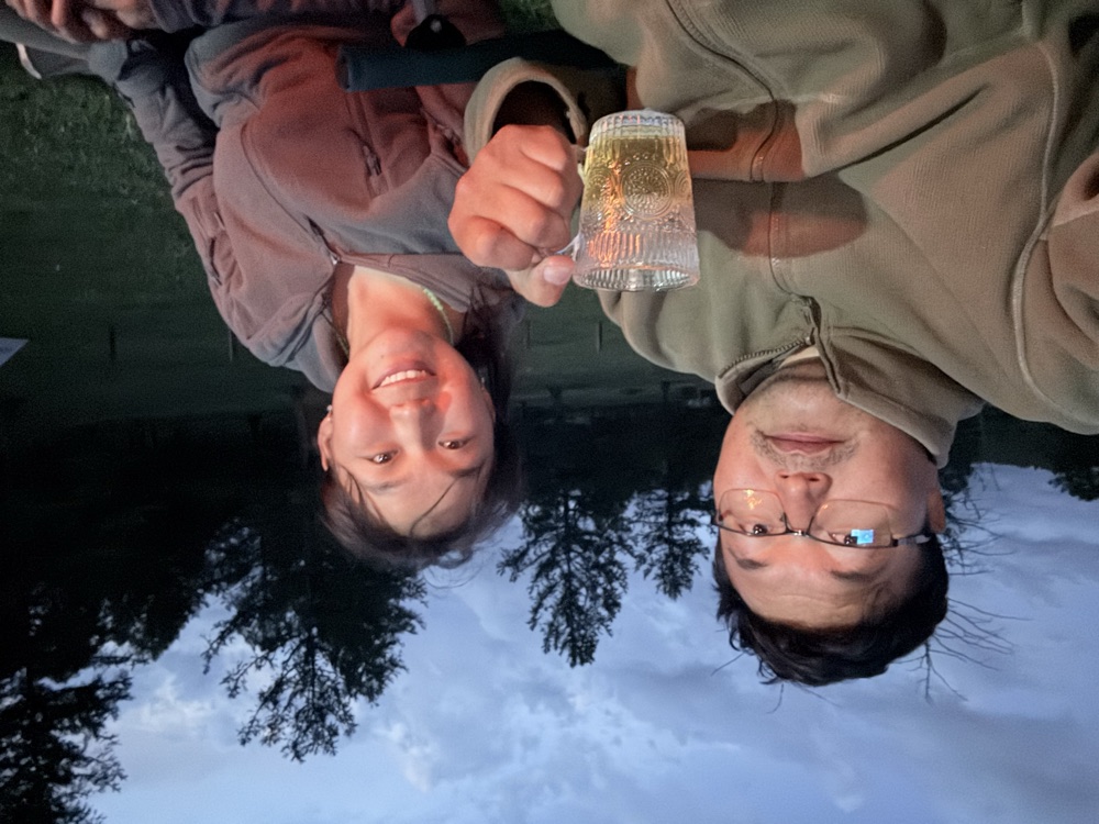The two of us sharing a drink at dusk beside the campsite
