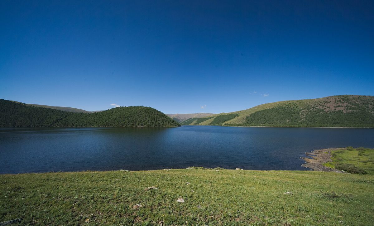 One of the Naiman Nuur lakes framed by forested hills